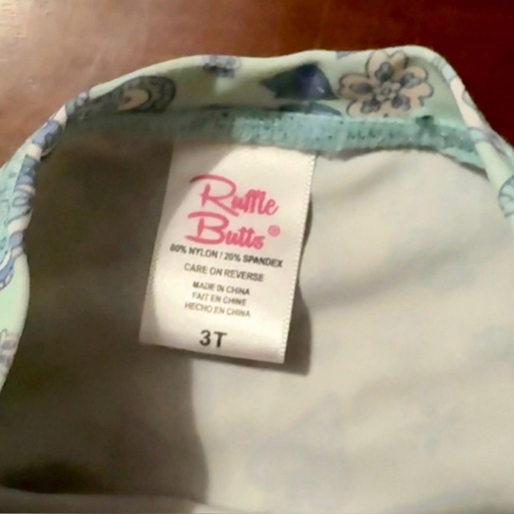 RuffleButts • Sea Glass
Paisley Rash Guard • Size 3t - Picture 6 of 7